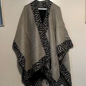 Women’s cape jacketexcellent condition. Tan with black stripes. Reversible.